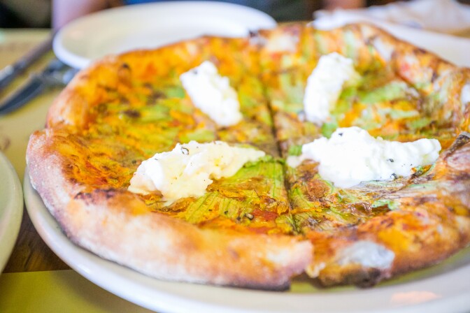 Squash blossom, tomato, and burrata pizza from Pizzeria Mozza (City Foodsters via Flickr Creative Commons)