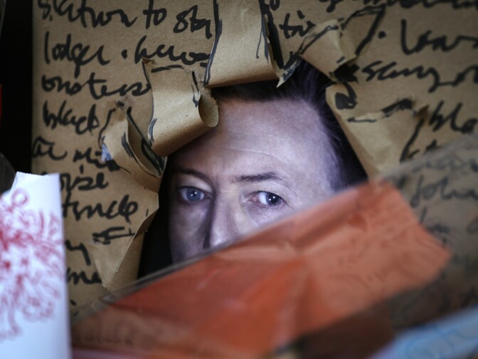 A poster is seen of British music legend David Bowie at a memorial outside of the residence in New York on January 11, 2016. Bowie has died at the age of 69 after a secret battle with cancer, unleashing a cascade of tributes for one of the most influential and innovative artists of his time. A notoriously private person, Bowie's death in New York was a shock to the world with the announcement coming just three days after he released his 25th studio album "Blackstar", on his 69th birthday on January 8. "David Bowie died peacefully today (Sunday) surrounded by his family after a courageous 18-month battle with cancer," said a statement posted January 11 on his official social media accounts.  AFP PHOTO/KENA BETANCUR / AFP / KENA BETANCUR        (Photo credit should read KENA BETANCUR/AFP/Getty Images)