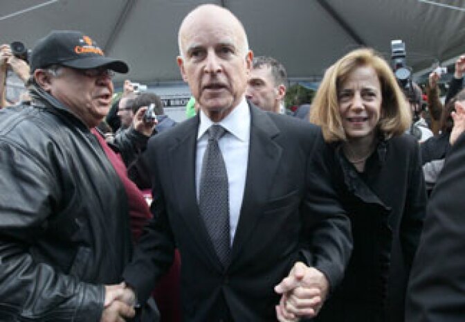California governor Jerry Brown (C) makes his way through a crowd with his wife Anne Gust Brown (R) during the People's Party after he was sworn in as the 39th governor of California by California on January 3, 2011 in Sacramento, California.