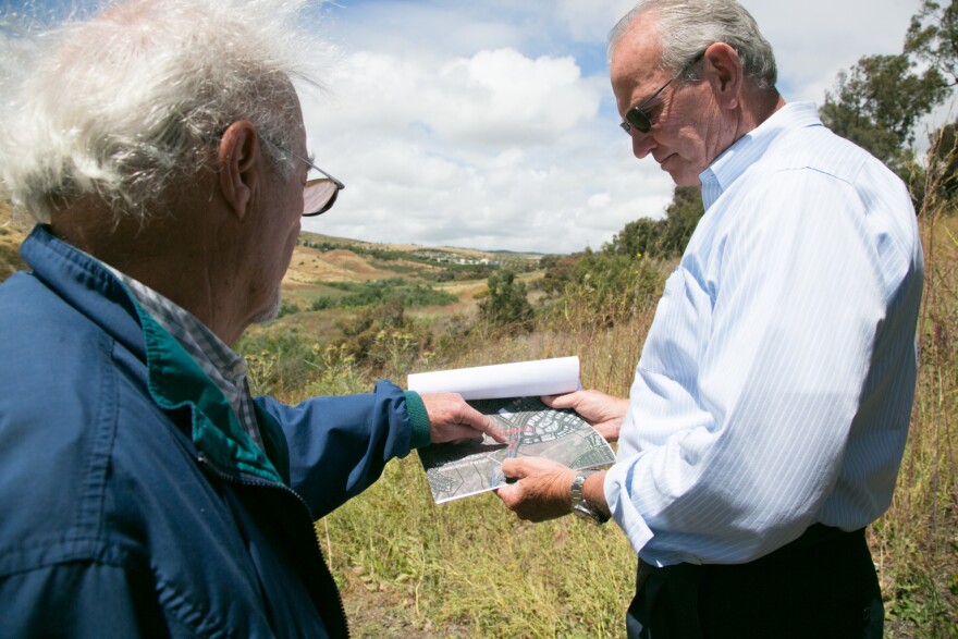 Bob Adams (left) of the Rancho San Clemente Business Park and Fred Holgate (right) of the Emergency Shelter Coalition tour a 10-acre parcel that the business park wants to donate to open a homeless shelter, May 21, 2019.