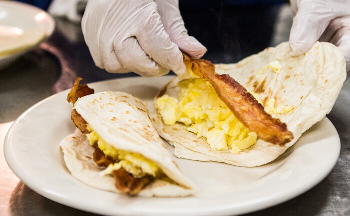 Scrambled eggs, cheese, beans and bacon in the breakfast tacos at Joe's Bakery in Austin, Texas.
