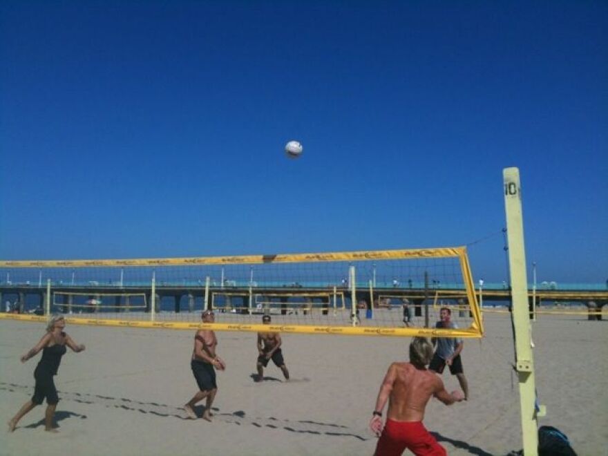 Beach-goers playing beach volleyball in Manhattan Beach. 