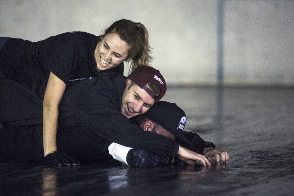 Ruth Duckworth, Eric Saunders and Chase McCullough lay on the ground for another team member to leap over them during a practice for Decayed Brigade at Chapman Sports Park in Garden Grove on Monday evening, Oct. 24, 2016.