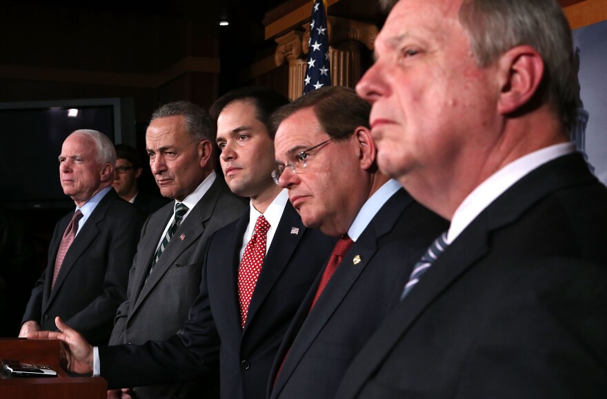 (L-R) U.S. Sen. John McCain (R-AZ), Sen. Charles Schumer (D-NY), Sen. Marco Rubio (R-FL), Sen. Robert Menendez (D-NJ), and Senate Majority Whip Sen. Richard Durbin (D-IL) listen during a news conference on a comprehensive immigration reform framework January 28, 2013 on Capitol Hill in Washington, DC. A group of bipartisan senate members have reached to a deal of outlines to reform the national immigration laws that will provide a pathway for the 11 million illegal immigrants in the country to citizenship.  
