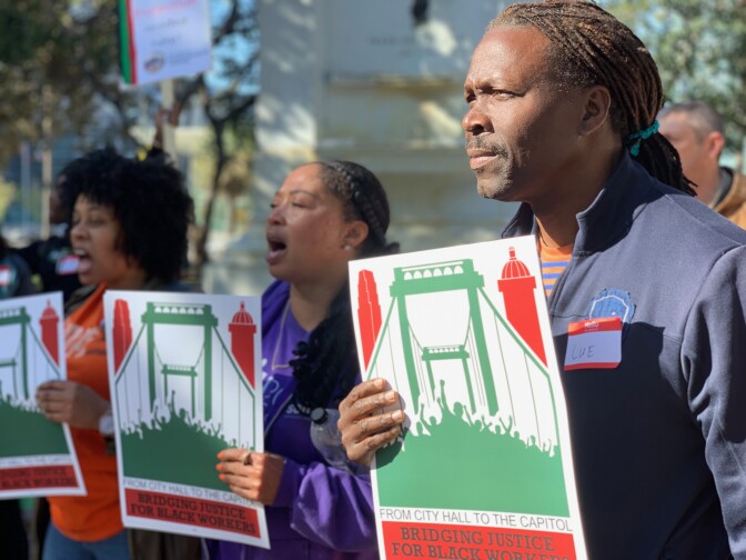 Workers with the L.A. Black Worker Center rally before the City Council vote establishing a civil rights commission. 
