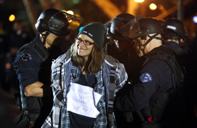 An Occupy Los Angeles protester is arrested by Los Angeles Police Department officers after LAPD raided the protest campsite in the early hours of November 30, 2011 in Los Angeles, California.