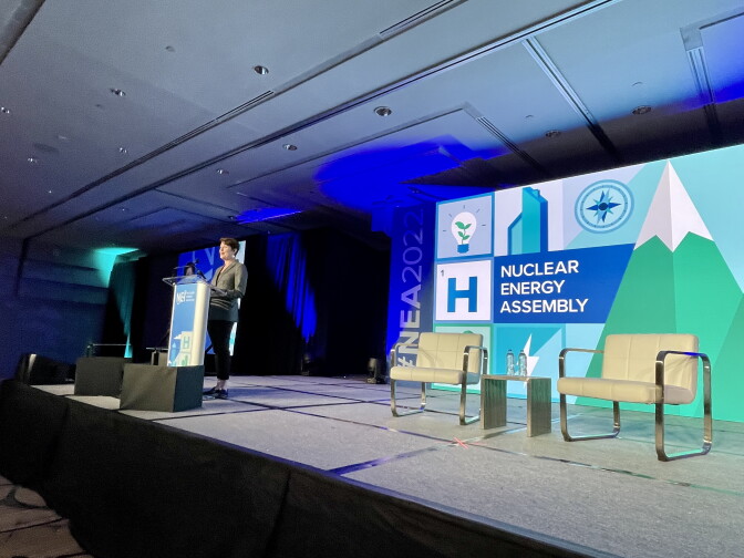 A woman speaks at a podium at the Nuclear Energy Assembly.