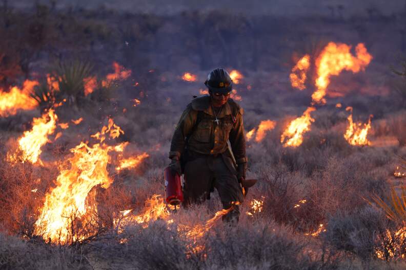 A man in burning brush.