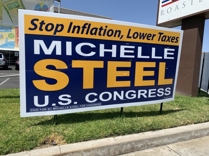 Blue and yellow lawn sign reads "Stop Inflation, Lower Taxes: Michelle Steel U.S. Congress"