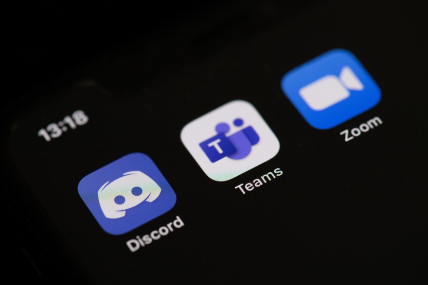 This illustration picture taken on May 27, 2020 in Paris shows the logos of the social networks  applications Zoom, Discord, and Teams on the screen of a phone. (Photo by Martin BUREAU / AFP) (Photo by MARTIN BUREAU/AFP via Getty Images)