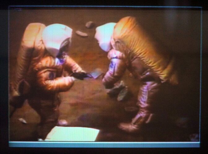 A photo taken from a monitor at the Korolev Space Mission Control  Center outside Moscow shows volunteers of the Mars500 experiment,  Van Yue of China and Alexander Smoleevskiy of Russia, taking a mock walk on Mars on February 18, 2011. Two members of a group of  volunteers isolated from the outside world for eight months stepped  out on a mock-up of Mars, half-way through their experiment to study  the effects of a Red Planet mission. The men's first steps were  relayed to the Russian control center that monitors real space  missions, as part of an experiment organized by the European Space  Agency and Moscow's institute of biomedical problems.  