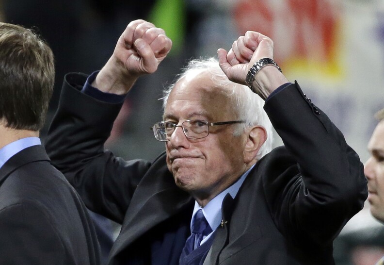 Democratic presidential candidate Sen. Bernie Sanders of Vermont pumps his fists as he leaves the field after speaking at a rally in Seattle on March 25, 2016. 