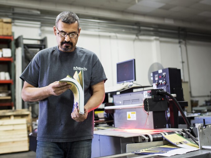 Machine Operator Lucio Sandoval gathers campaign mailers from an address printer at Mellady Direct Marketing in Santa Clarita, Calif. on Thursday morning, Oct. 6, 2016. The addresses are separated and organized based on each mail carrier's route. Sandoval will place these mailers into trays that are delivered directly to carriers.