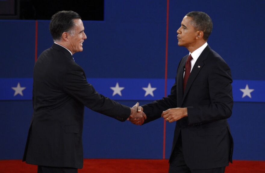U.S. President Barack Obama (R) and Republican presidential candidate Mitt Romney (L) shake hands following the second presidential debate at the David Mack Center at Hofstra University in Hempstead, New York, October 16, 2012, moderated by CNN's Candy Crowley.
