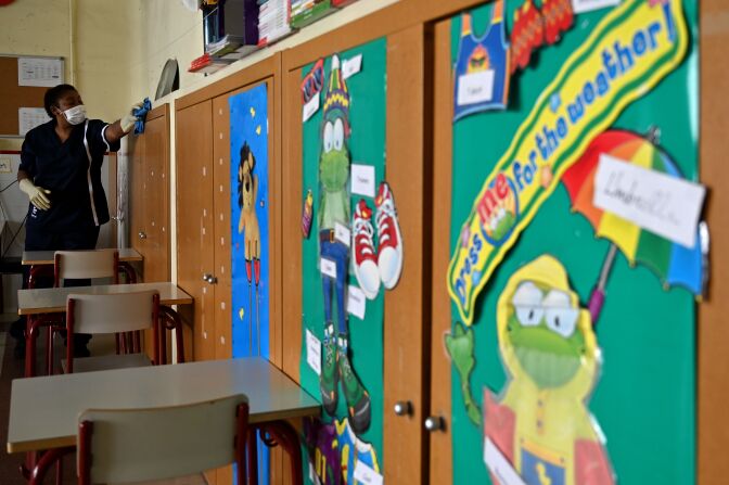 A cleaning staff member disinfects a classroom prior to the reopening of a school in Madrid amid the coronavirus pandemic on September 8, 2020. - Spain, that yesterday passed the landmark figure of 500,000 coronavirus infections, had largely gained control over its outbreak by imposing one of the world's toughest lockdowns, but infections have surged since the restrictions were fully removed at the end of June. (Photo by Gabriel BOUYS / AFP) (Photo by GABRIEL BOUYS/AFP via Getty Images)