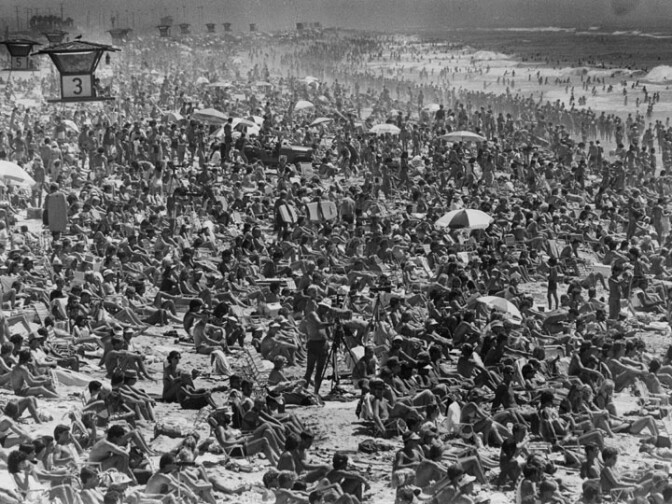 Sept. 3, 1983: Spectators crowd Huntington Beach for surfing championships, which continue today, and one onlooker, ..." and "Surfing fans found little room to spread out their towels as thousands flocked to the shores of Huntington Beach to watch the OP surfing contest Saturday". The U.S. Open of Surfing is a week-long surfing competition held annually during the summer in Huntington Beach, California. Photograph dated: 