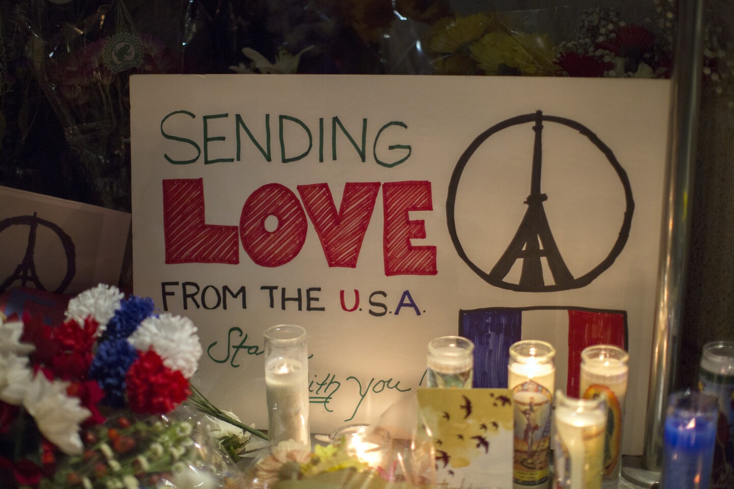A sign sends a message of love from the Untied States to France at a makeshift memorial outside the French Consulate  in Los Angeles, California on November 14, 2015, one day after the Paris terrorist attacks.  Stirring renditions of "La Marseillaise" rang out from Dublin to New York as global landmarks were bathed in the French colors and thousands marched in solidarity with Paris after attacks that left at least 129 dead. 