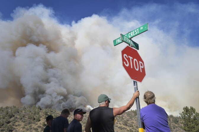 Bystanders watch the progress of the Blue Cut Fire near a subdivision of Wrightwood Wednesday afternoon. The Blue Cut Fire burns in San Bernardino County on Wednesday, Aug. 17, 2016.