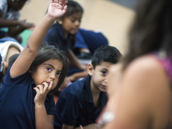 Kindergartener Dalilah DeAnda listens as teacher Cherie Wood reads a book aloud at Willard Elementary School in Pasadena, two weeks into the school year, on Wednesday morning, Aug. 31, 2016.