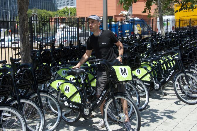 A rider checks out a bike share bicycle downtown.