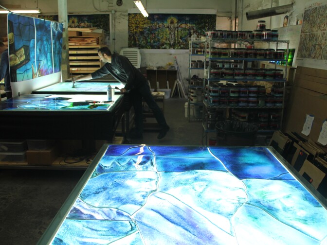 In the basement of the Judson Studios, artist Tim Carey is using the fusing technique. 
