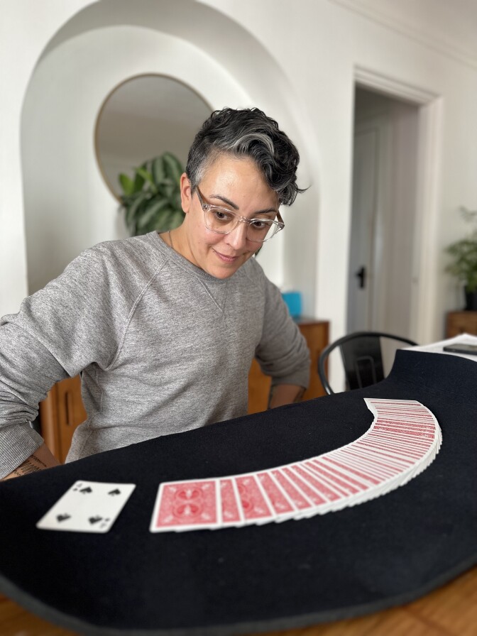 Carly Usdin looks at a spread of cards 
