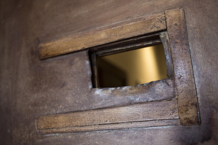 A hole cut out in this wooden door is a remnant of a speakeasy that opened inside the Italian Hall during Prohibition in the 1920s and early 1930s.