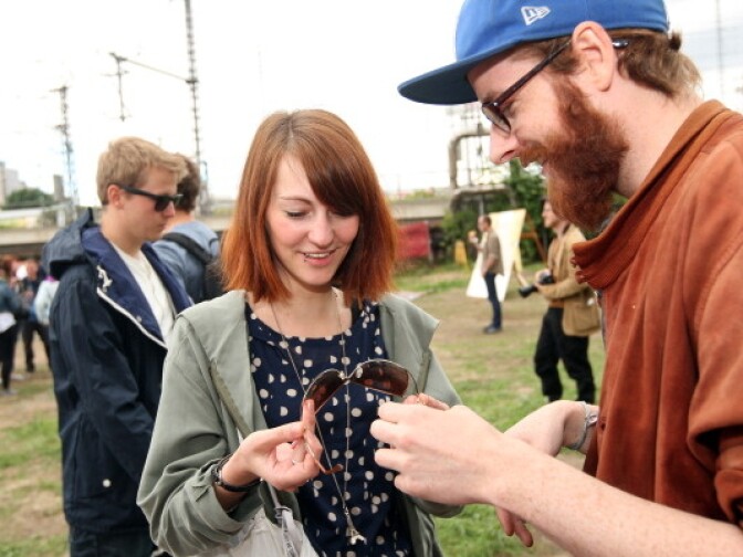 Attendees look at a pair of sunglasses from a 'swap box,' where visitors can take items in exchange for leaving others, at the second annual Hipster Olympics on July 21, 2012 in Berlin, Germany.