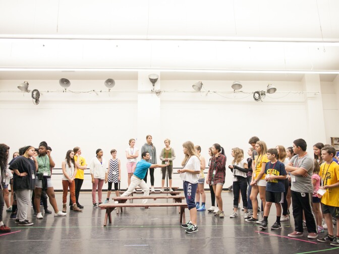 Stage director Eli Villanueva (center) works with students at LA Opera Camp Los Angeles, Calif. on Wednesday, Aug. 4, 2015. 