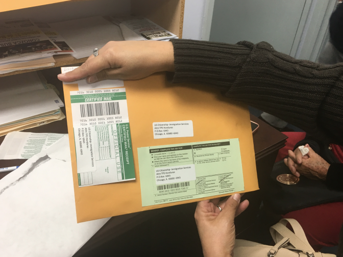 Dilcia Inestroza, an immigrant from Honduras, holds her renewal package for Temporary Protected Status. She's had the protected status, which lets her live and work legally in the United States, for nearly 20 years. It was granted to Honduran immigrants in the U.S. after Hurricane Mitch devastated that country in 1998. She fears this could be the last time she's allowed to renew her protection.