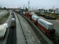 Trucks move along the I-710 freeway in the predawn hours of Thursday, July 7, 2005, into the Port of Long Beach, Calif.