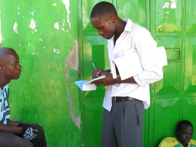 A health worker in western Kenya talks to young men about the benefits of male circumcision.