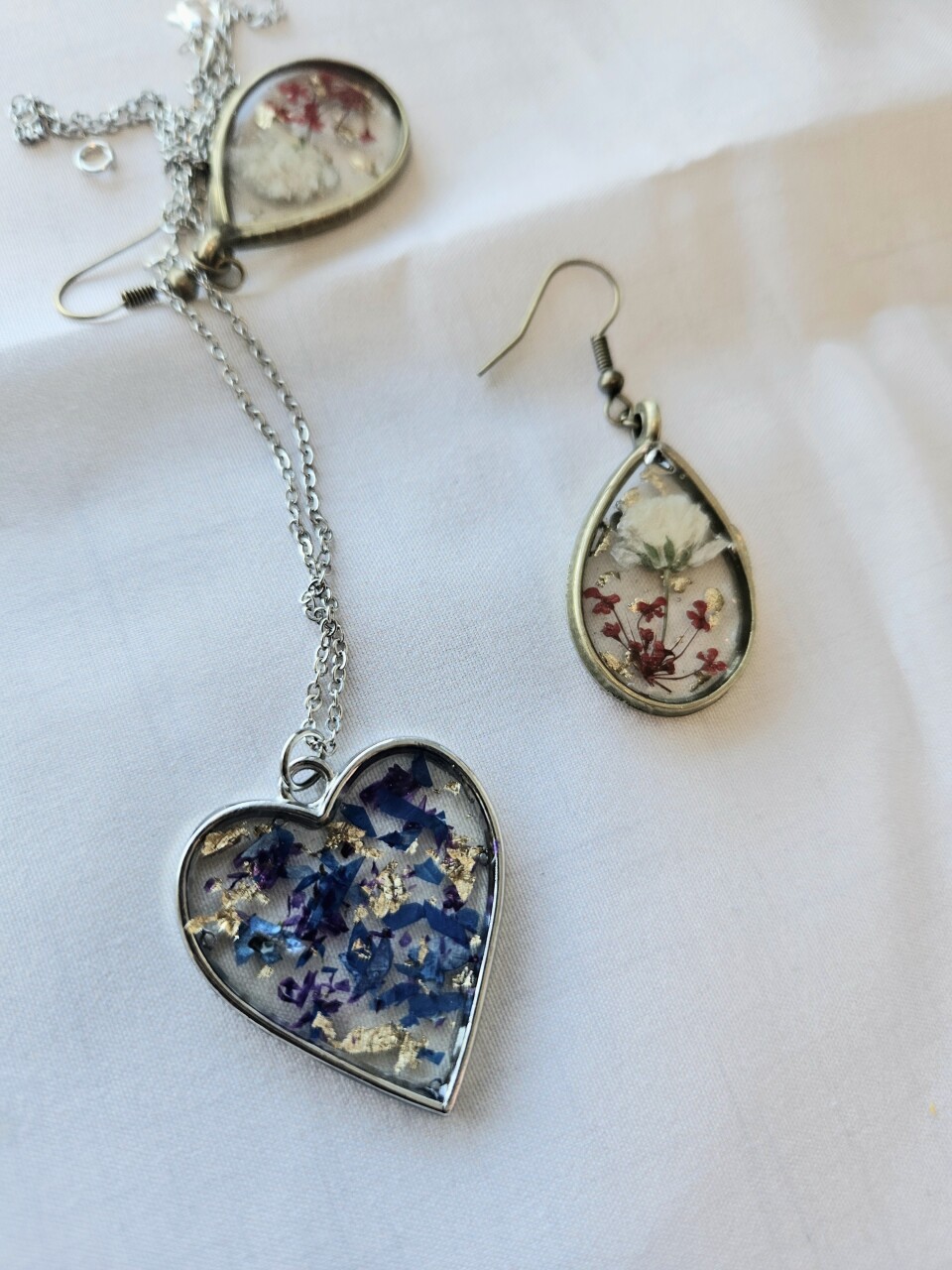 Jewelry shaped like hearts and teardrops, with flower designs.