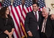 Representative-elect Jimmy Gomez, D-Calif., center, puts his arm around his mother Socorro Gomez, right, as he wife Mary Hodge look on at left, before participating in a ceremonial swearing-in on Capitol Hill in Washington, Tuesday, July 11, 2017.