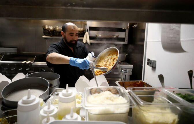 SAN FRANCISCO, CALIFORNIA - MARCH 27: Julio Mis, the executive sous chef at Sociale, prepares dinners for delivery and curbside pickup in the kitchen with a reduced staff on March 27, 2020 in San Francisco, California. Sociale is working with a staff of only four people, and are offering curbside pickup during the coronavirus (COVID-19) shutdown. On Friday nights, they are also offering delivery to the Nichol's home town of San Anselmo in Marin County just north of San Francisco. (Photo by Ezra Shaw/Getty Images)