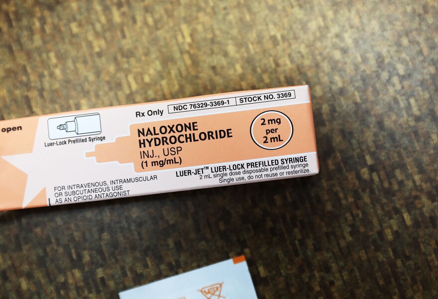 A box contains doses of Naloxone, which countermands overdoses.