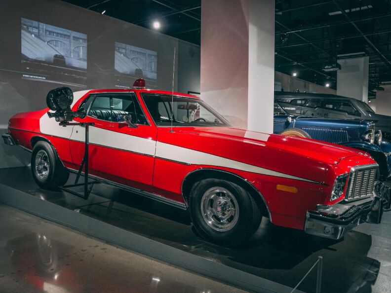 A 1970s red and white Ford Gran Torino on display.