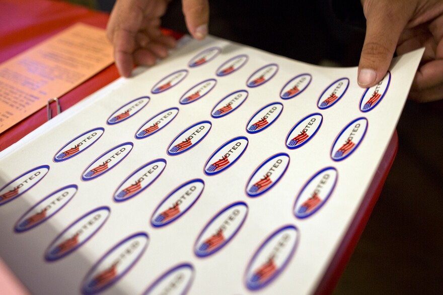 Poll workers give out "I Voted" stickers during the Los Angeles County primary election on Tuesday, March 3, 2015 at Saint Mary of the Angels in Los Feliz.
