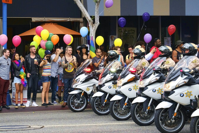 Los Angeles County Sheriff's department motorcycle deputies ride along a street in West Hollywood, Calif., during the Gay Pride Parade on Sunday, June 12, 2016. A heavily armed man arrested in Southern California told police he was in the area for West Hollywood's gay pride parade.