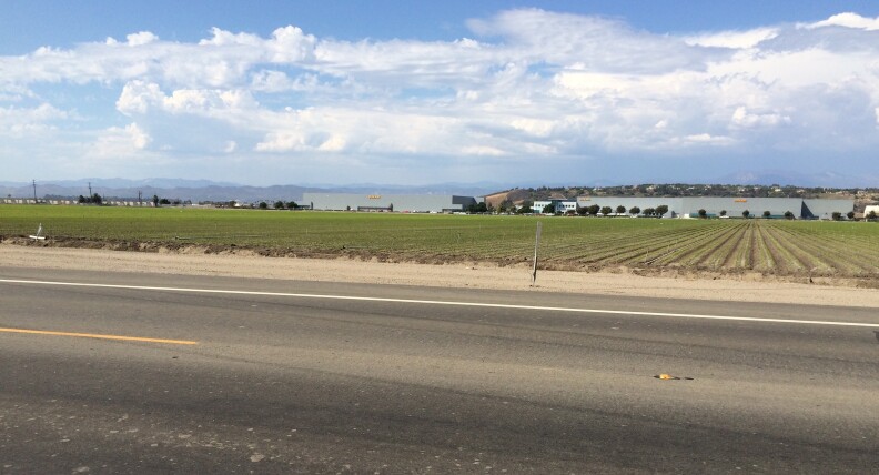 An field near Oxnard where agricultural land is wedged among businesses, housing and busy highways.