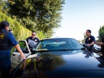 On August 21, 2012, North Hollywood's Probation Compliance Unit discusses the day's next home visit. As part of California's current AB 109 "prison realignment" scheme that gives low-level offenders the possibility of early probation to ease prison over-crowding, the team makes random visits to former prisoners to make sure they are following the terms of their probation.