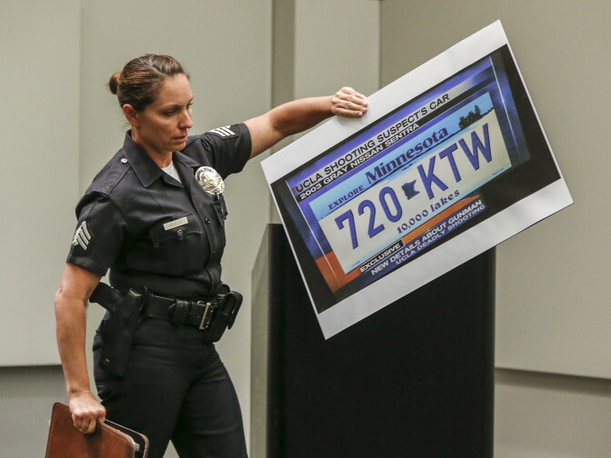 Los Angeles police detective Meghan Aguilar sets up an illustration of a Minnesota license plate of the missing car driven by Mainak Sarkar at a news conference on the investigation into a murder-suicide on the UCLA campus in Los Angeles Thursday, June 2, 2016. 
