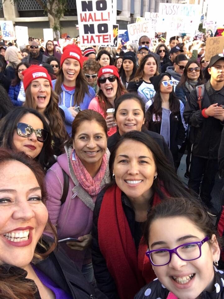Nubia Cedeño, with sunglasses, along with other marchers in downtown Los Angeles last Saturday. Cedeño said as a parent and member of an immigrant family, she was motivated to march to advocate for education and immigrant rights.