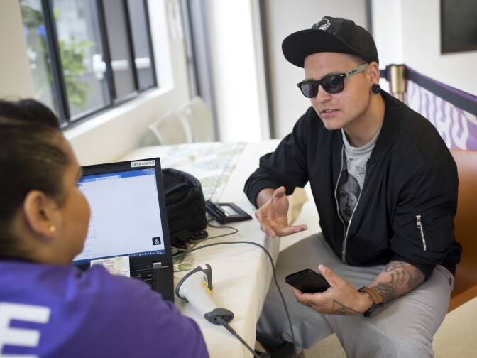 Joseph Atherton hoped to get a cell phone through SOS with his new identification card on Friday morning, May 29, 2015. But Atherton found out he needs to be enrolled a government assistance program to qualify. Atherton hopes that having a phone number will help him be more competitive while applying for jobs.