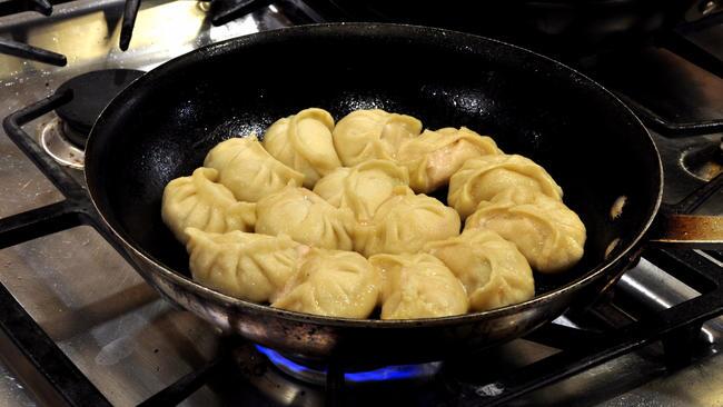 Homemade pan-fried pork and cucumber potstickers.