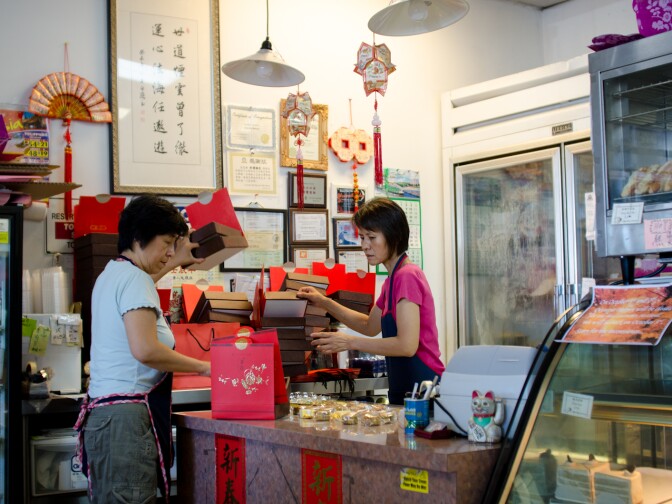 Nancy Yang, owner of Olympic Bakery, and Cindy Sun prepare an order of more than 50 boxes of Mooncake in Temple City, Calif., Monday September 24, 2012. The small pastries are made for the Chinese Moon Festival which takes place during the eight lunar month each year.