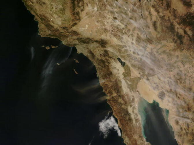 IN SPACE - OCTOBER 21:  In this handout provided by NASA, an image captured by NASA's Terra satellite at 11:35 a.m. PST, shows several fires giving off small plumes of smoke October 21, 2007. Powerful Santa Ana winds have fueled more than 10 large wildfires throughout Southern California, stretching from Santa Barbara to San Diego. Just over 3 hours later, at 2:50 p.m. PST when NASA's Aqua satellite passed overhead, large amounts of smoke were pouring from blazes northwest of Los Angeles. Actively burning fires are outlined in red (By NASA).  (Photo by NASA via Getty Images)