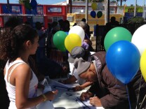 South LA residents sign in to attend the South LA Power Festival, an event organized around providing information on health care coverage.