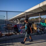 An unemployed upholsterer, Israel Yaxon 28 years-old, who has lived for one year on the street, walks outside his tent over the bridge of the 110 Freeway, during the novel Coronavirus, COVID-19, pandemic in Los Angeles California on May 25, 2020. - On May 22, 2020 a federal judge issued a preliminary order requiring that  homeless people living under Los Angeles freeway overpasses and underpasses, be relocated for health and safety reasons. (Photo by Apu GOMES / AFP) (Photo by APU GOMES/AFP via Getty Images)
