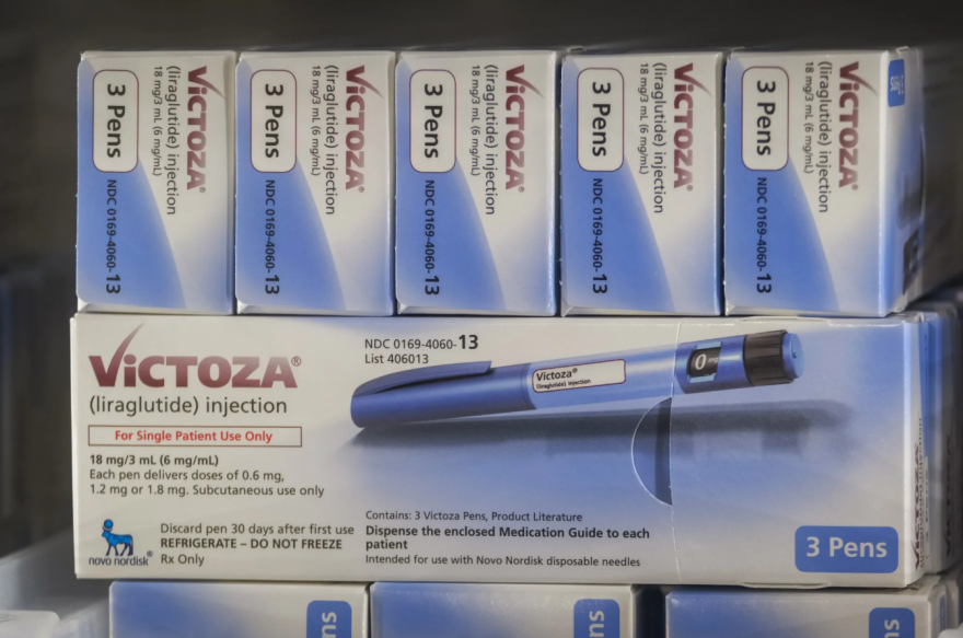 A stack of boxes on one another each showing a pen and text that reads "Victoza (liraglutide) injection".